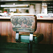 Restaurant Counter Stool with Painting of Cottage and Man Fishing on Back Support