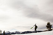 Man takes the skins off his skis in the backcountry of Montana.