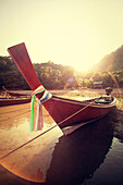 traditional thai longboat, the sun sets in the town of gypsies.Koh Lanta Thailand