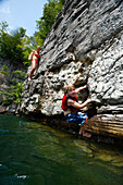 Will Chouinard works to climb out of the water while his mother, Sarah Chouinard, looks on at Summersville Lake, WV