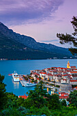 Elevated view over Korcula's picturesque Stari Grad (Old Town) illuminated at dusk, Korcula Town, Korcula, Dalmatia, Croatia, Europe