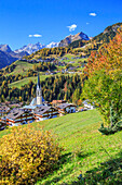 The villages of Selva di Cadore and Colle Santa Lucia, in the Dolomitic Cadore Region, surrounded by yellow larches in autumn, Veneto, Italy, Europe