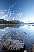 Piz da la Margna reflecting in Lake Sils by Saint Moritz in Engadine, Graubunden, Switzerland, Europe