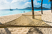Hammock between two palms on a sandy beach, Palm Island, The Grenadines, St. Vincent and the Grenadines, Windward Islands, West Indies, Caribbean, Central America