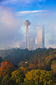 Mist from Horseshoe Falls swirling in front of Skylon Tower at dawn, Niagara Falls, Niagara, Ontario, Canada, North America