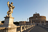 Angel statues on Ponte Sant' Angelo bridge with Castel Sant' Angelo, Rome, Lazio, Italy, Europe