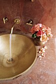 Detail of brass hand beaten bathroom sink in bathroom area of a residence, Amber, near Jaipur, Rajasthan state, India, Asia