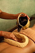 Kathi Vasti Treatment, an Ayurvedic procedure retaining warm medicated oil over the lower back within a border of herbal paste