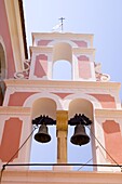 The pink and white belltower of Agios Triada in Gaios, Paxos, Ionian Islands, Greek Islands, Greece, Europe