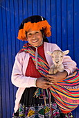 Inca woman in traditional dress with small lamb, Pisac, Sacred Valley, Peru, South America