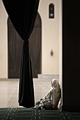 Woman sitting in the Mosque of Al-Hakim, Cairo, Egypt, North Africa, Africa