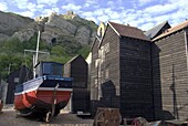 Fishing boat and historic buildings with Hastings Castle in the background, Hastings, Hastings, Sussex, England, United Kingdom, Europe