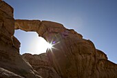 Sun's rays, natural rock arch, desert scenery, Wadi Rum, Jordan, Middle East