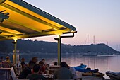 A waterside taverna at dusk in Lakka, Paxos, Ionian Islands, Greek Islands, Greece, Europe