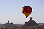 Hot air balloon and rock formations at dawn, Valley of the Gods, Utah, United States of America, North America