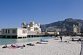 Sunbathers on beach near the pier, Mondello, Palermo, Sicily, Italy, Europe