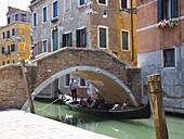 Gondola passing beneath the Ponte Ruga Vecchia, Santa Croce district, Venice, Veneto, Italy, Europe