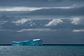 Iceberg and storm clouds, near Halfmoon Island, South Shetland Islands, Antarctica