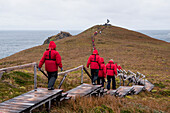 Passengers from expedition cruise ship MS Hanseatic (Hapag-Lloyd Cruises) en route to Albatros monument, Cape Horn, Cape Horn National Park, Magallanes y de la Antartica Chilena, Patagonia, Chile, South America