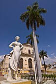 Statue in front of the Plaza Mayor with Iglesia Parroquial de la Santisima Trinidad, Trinidad, UNESCO World Heritage Site, Cuba, West Indies, Caribbean, Central America