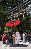 Mikoshi procession under torii gate at Futarasan Shrine during the Shunki Reitaisai festival in Nikko, Tochigi, Japan, Asia