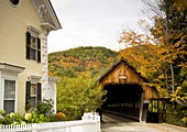 Middle Bridge, a covered wooden bridge surrounded by autumn foliage in the scenic town of Woodstock, Vermont, New England, United States of America, North America