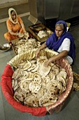 Chapatti making in the communal kitchen of Bangla Sahib Gurdwara, New Delhi, India, Asia