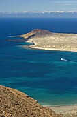 Volcanic cinder cone on Graciosa Island and the Graciosa to Lanzarote ferry in the Rio strait, seen from the Mirador del Rio on the north west coast of Lanzarote, Graciosa Island, Canary Islands, Spain, Atlantic, Europe