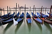 Gondolas moored by St. Marks Square, looking across to Isola di San Giorgio Maggiore in the early morning, Venice, UNESCO World Heritage Site, Veneto, Italy, Europe