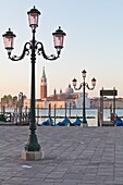 Gondolas moored on the Lagoon, San Giorgio Maggiore beyond, Riva degli Schiavoni, Venice, UNESCO World Heritage Site, Veneto, Italy, Europe