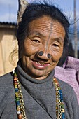 Old woman of the Apatani tribe famous for the wooden pieces in their nose to make them ugly, Ziro, Arunachal Pradesh, Northeast India, India, Asia