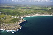Aerial photo of Lands End Peninsula looking east to the Minnack Theatre and Porthcurno beach, West Penwith, Cornwall, England, United Kingdom, Europe
