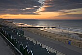 A spectacular sunrise over the beach huts on Bournemouth Beach, Dorset, England, United Kingdom, Europe