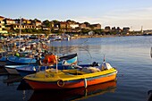 Fishing boats and view towards ramparts and ruins of the medieval fortification walls, Nessebar, Black Sea, Bulgaria, Europe