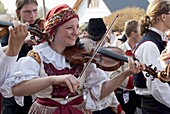 Woman playing violin and wearing folk dress during autumn Feast with Law Festival, Borsice, Brnensko, Czech Republic, Europe