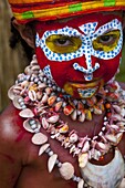 Colourfully dressed and face painted local child celebrating the traditional Sing Sing in the Highlands of Papua New Guinea, Pacific