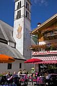 Church and cafe, Alleghe, Belluno Province, Veneto, Dolomites, Italy, Europe