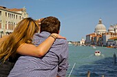 Couple looking along the Grand Canal, Dorsoduro, Venice, UNESCO World Heritage Site, Veneto, Italy, Europe