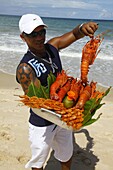 Man selling lobsters and prawns on the beach, Trancoso, Bahia, Brazil, South America