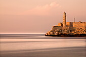 Evening view from The Malecon towards the Castillo de San Salvador de la Punta, Havana, Cuba, West Indies, Central America