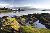 Early morning view of Plokton with houses and foreshore bathed in sunlight, Plokton, near Kyle of Lochalsh, Highland, Scotland, United Kingdom, Europe