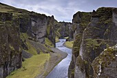 Fjadrargljufur Canyon, 100m deep and 2 km long, carved out of palagonite and lava layers by glacial river two million years ago, near Kirkjubaejarklaustur, South Iceland, Iceland, Polar Regions