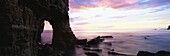 Dawn view over North Sea from beach at Marsden Bay, showing natural rock arch in Marsden Rock, South Shields, Tyne and Wear, England, United Kingdom, Europe
