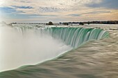 Blurry slow motion water at the top of the  Horseshoe Falls waterfall on the Niagara River, Niagara Falls, Ontario, Canada, North America