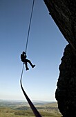 A climber abseiling from a cliff in the Ogwen Valley, Snowdonia, North Wales, United Kingdom, Europe