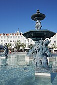 Statues and fountain with elegant buildings beyond, Praca Dom Pedro IV (Rossio Square), Lisbon, Portugal, Europe