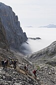 Hikers in the Picos de Europa National Park, shared by the provinces of Asturias, Cantabria and Leon, Spain, Europe