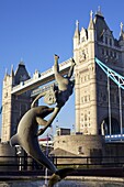 Girl and the dolphin statue and Tower Bridge, London, England, United Kingdom, Europe