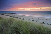 Sunrise over the Christchurch Bay, viewed from Hengistbury Head, Dorset, England, United Kingdom, Europe