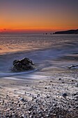 Sunset on the pebbly beach at Worbarrow, Jurassic Coast, UNESCO World Heritage Site, Dorset, England, United Kingdom, Europe